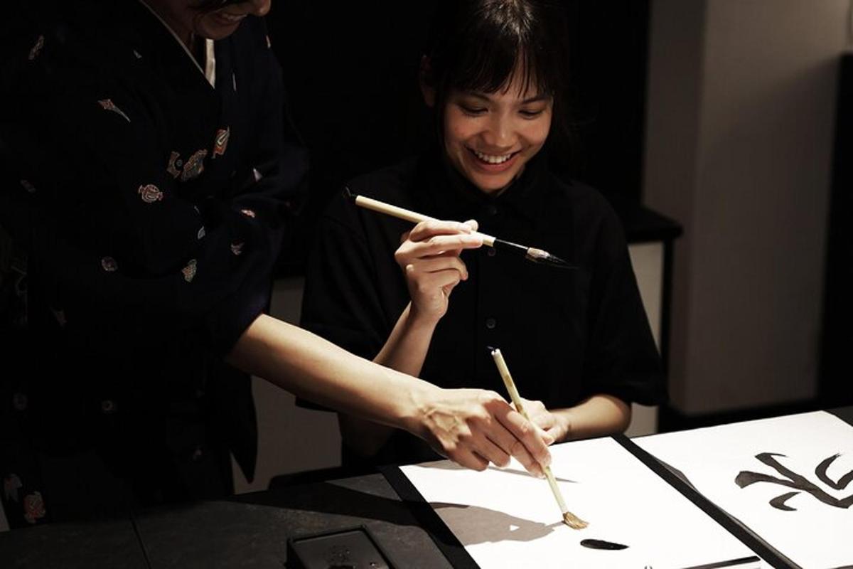 a woman holding two chopsticks in front of a table