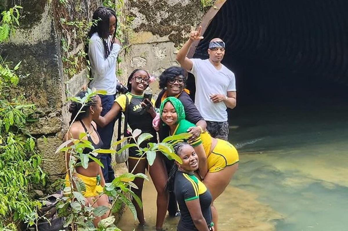 um grupo de pessoas em pé em frente a uma caverna