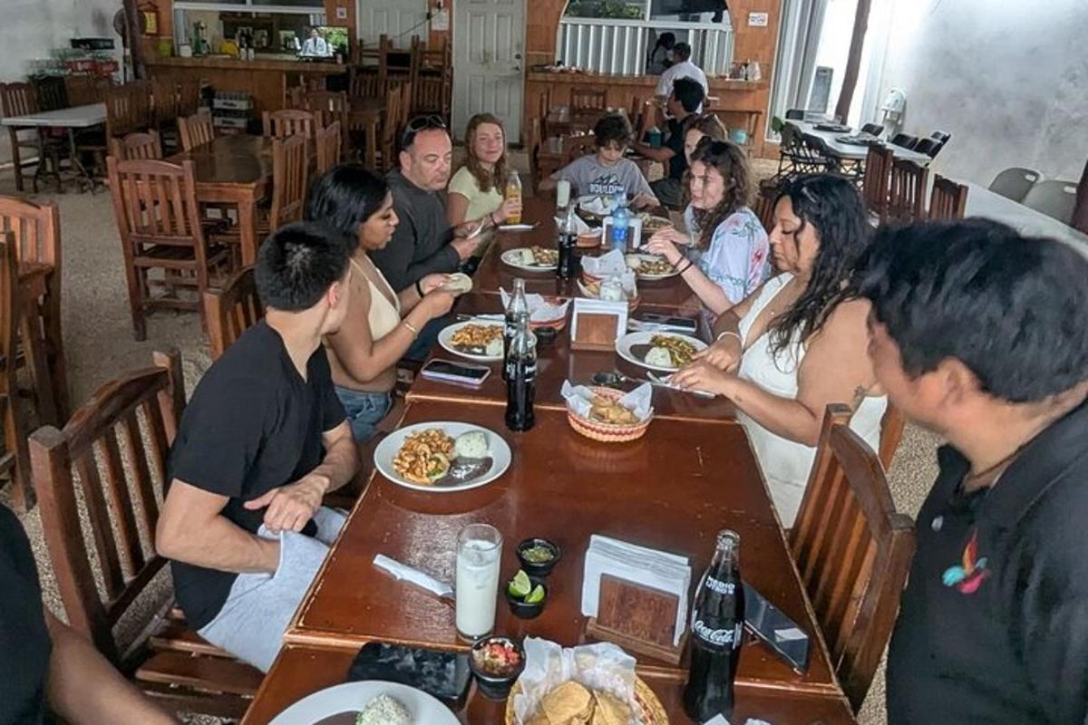 a group of people sitting at a table eating food