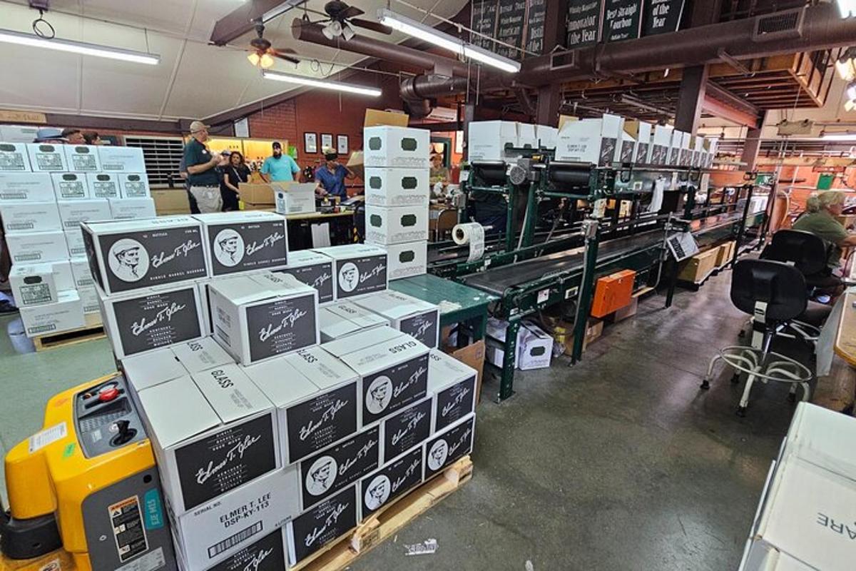 a warehouse with boxes and people in a room
