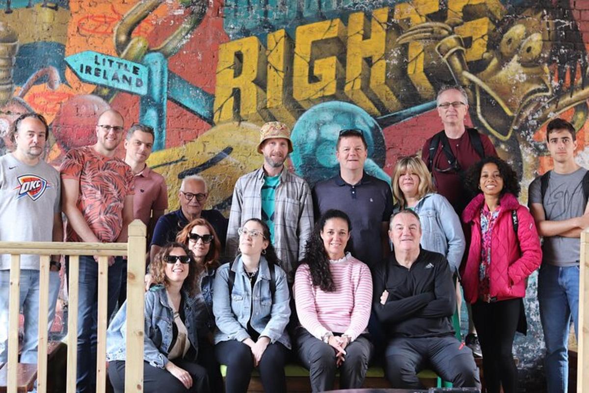 a group of people posing for a picture in front of a wall