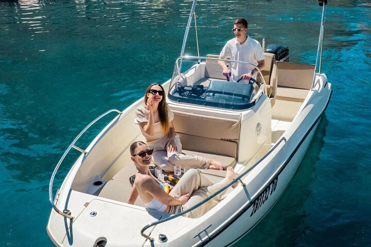 three people sitting on a boat in the water