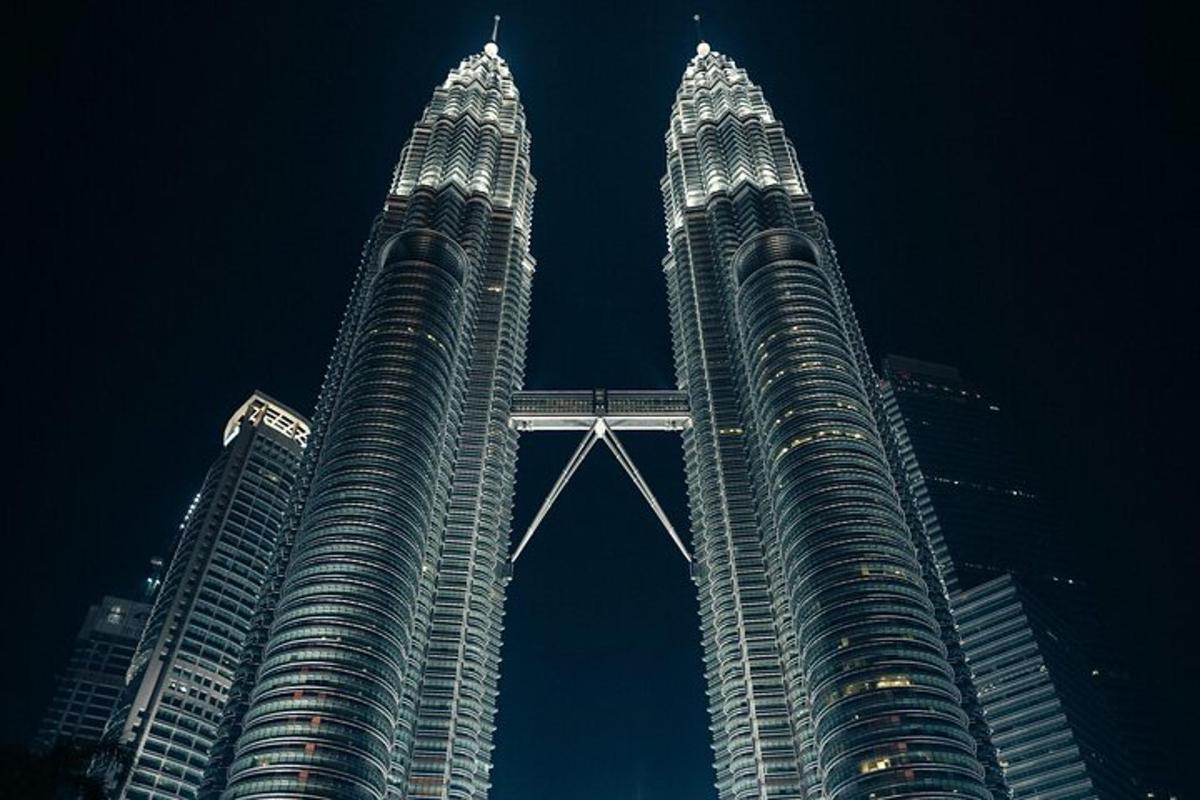 two tall skyscrapers in a city at night