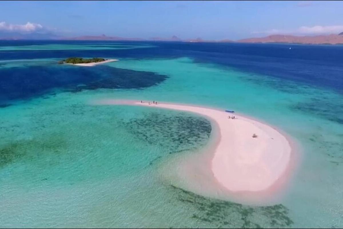 an island with a large white island in the water