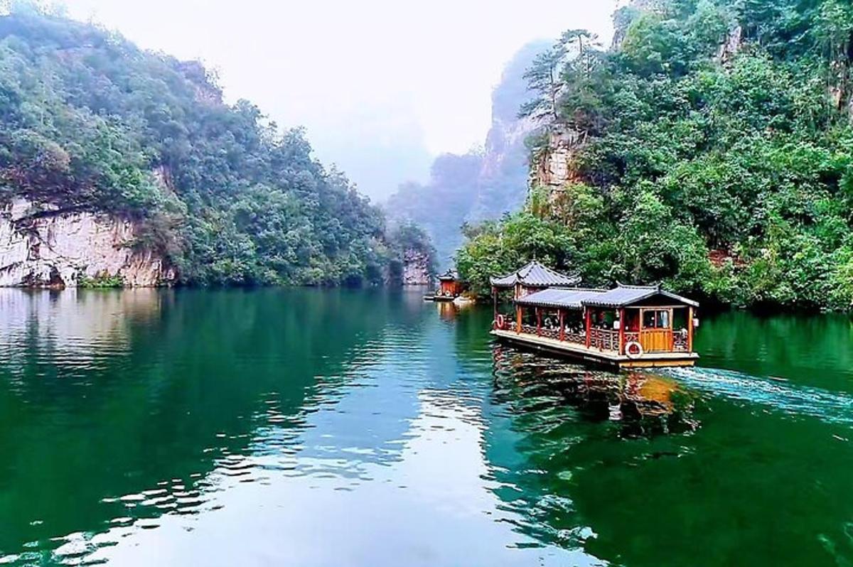 a boat on the water in a river with trees