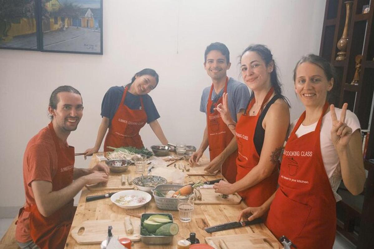 a group of people standing around a table preparing food