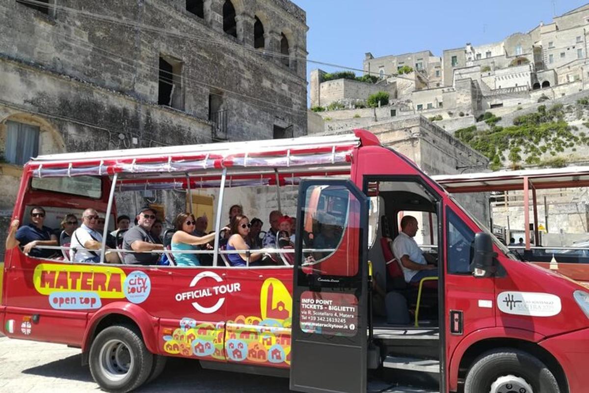 skupina lidí jedoucích v červeném autobuse