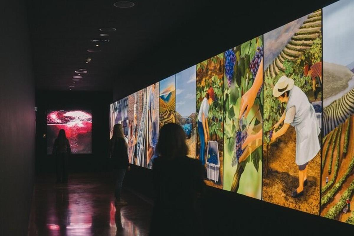 a group of people looking at paintings on a wall