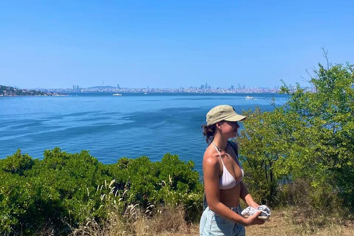 a woman in a bikini standing next to a body of water