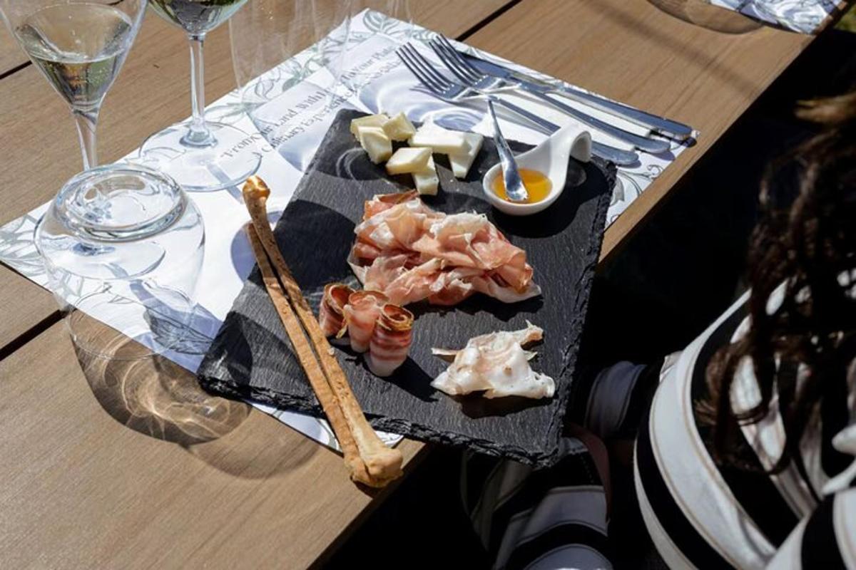 un piatto di cibo su un tavolo con bicchieri di vino