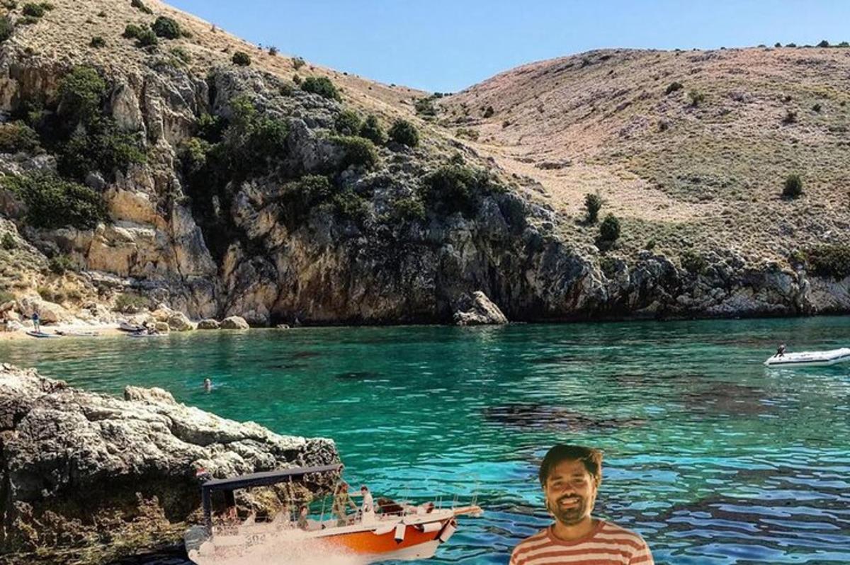 a man standing in the water next to a boat