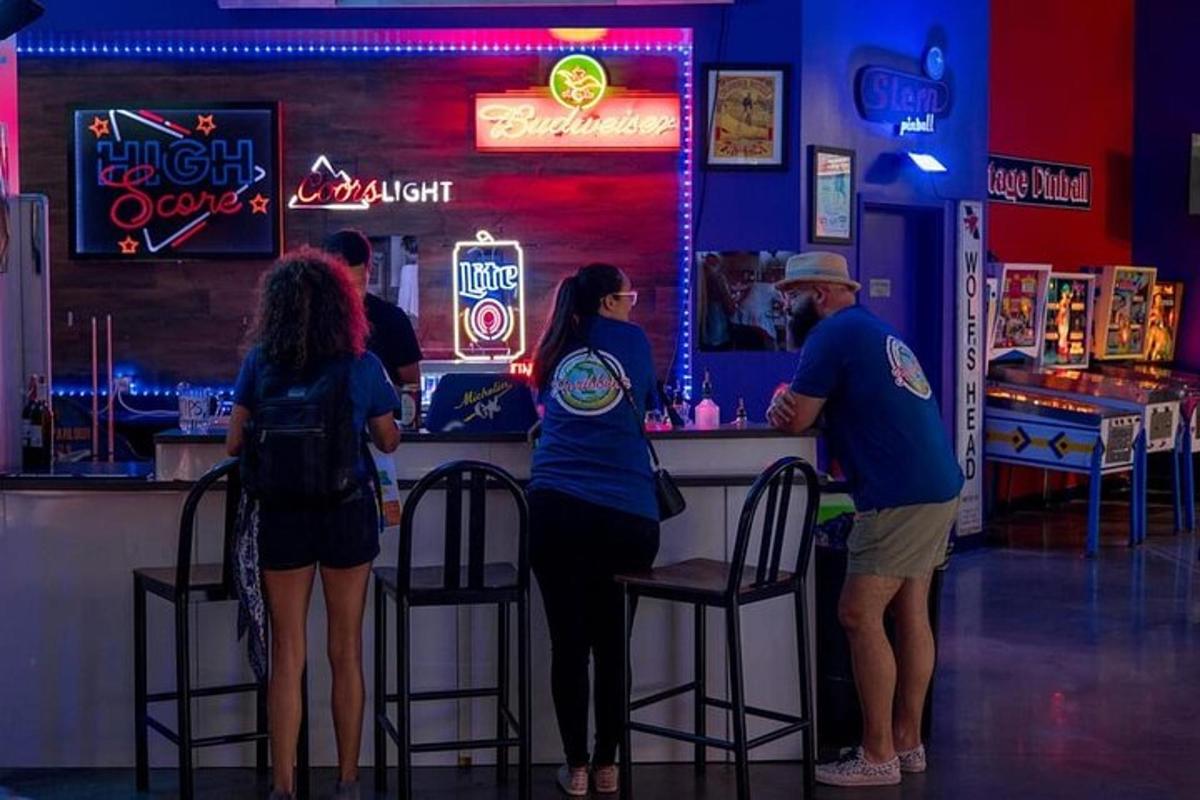 a group of people standing at a bar