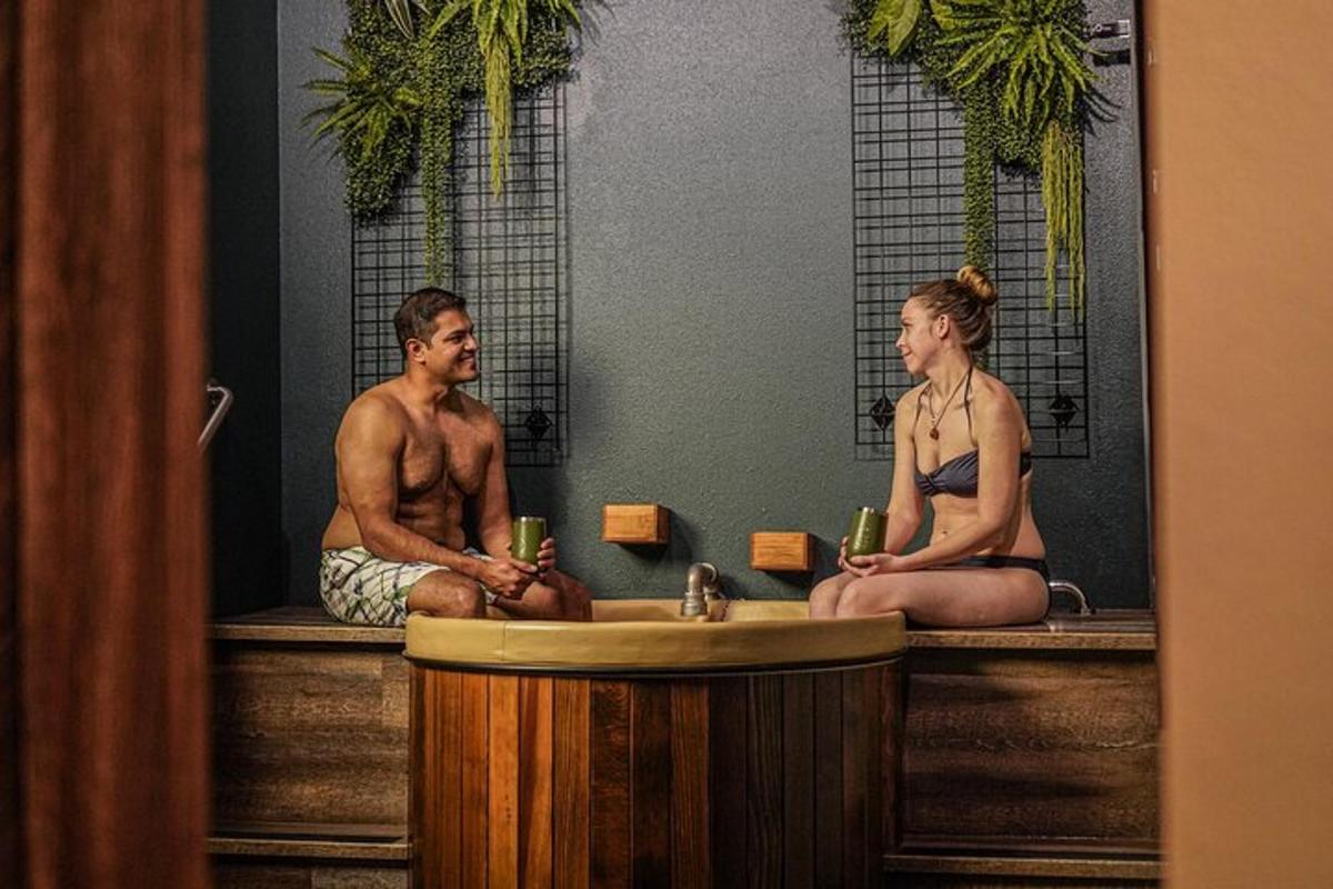 a man and a woman sitting in a bath tub
