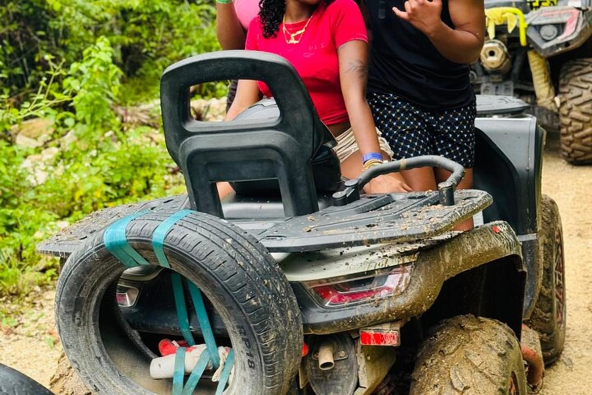 two people riding on an off road toy vehicle