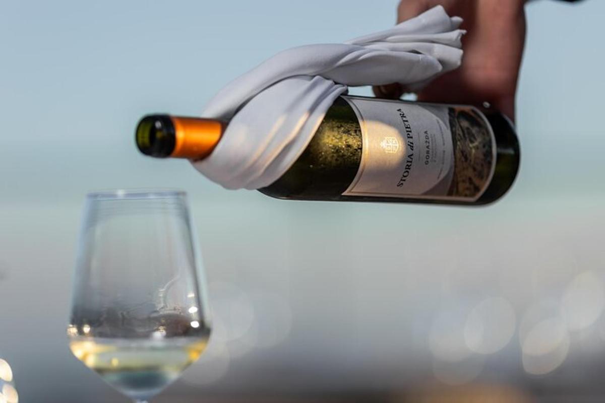 a bottle of wine being poured into a wine glass