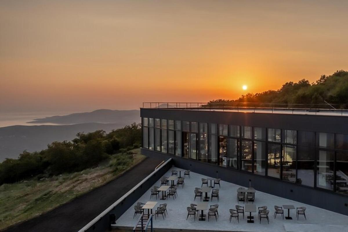 a view of a building with a sunset in the background