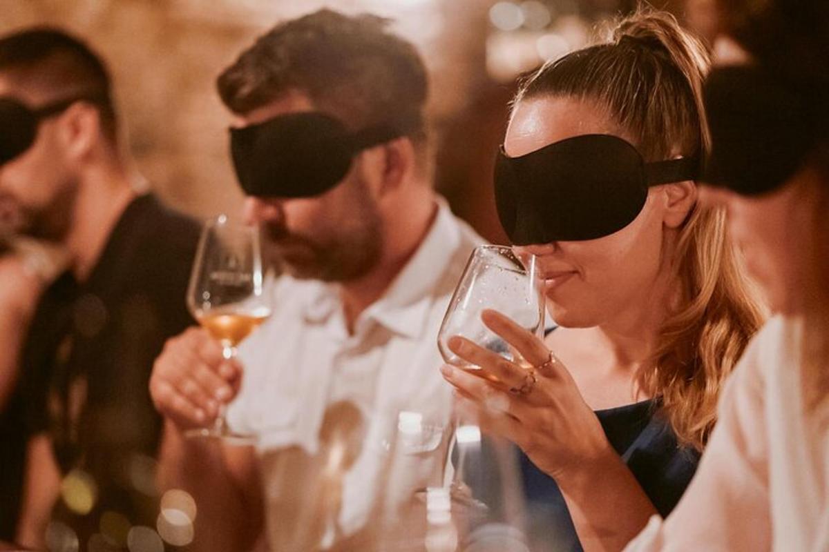 a woman looking at her cell phone at a party with wine glasses