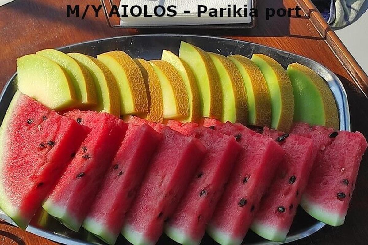 a bunch of slices of watermelon and apples on a plate