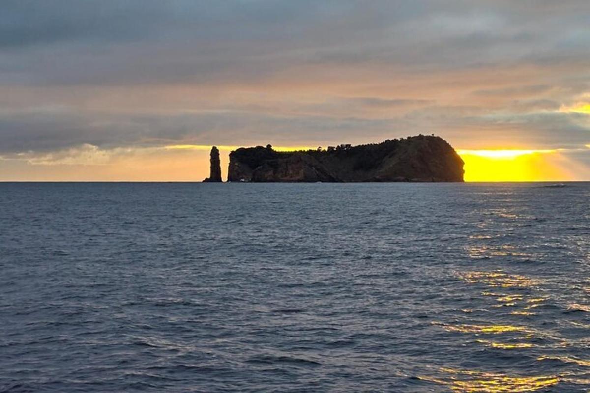 en øy i havet med solnedgangen i bakgrunnen