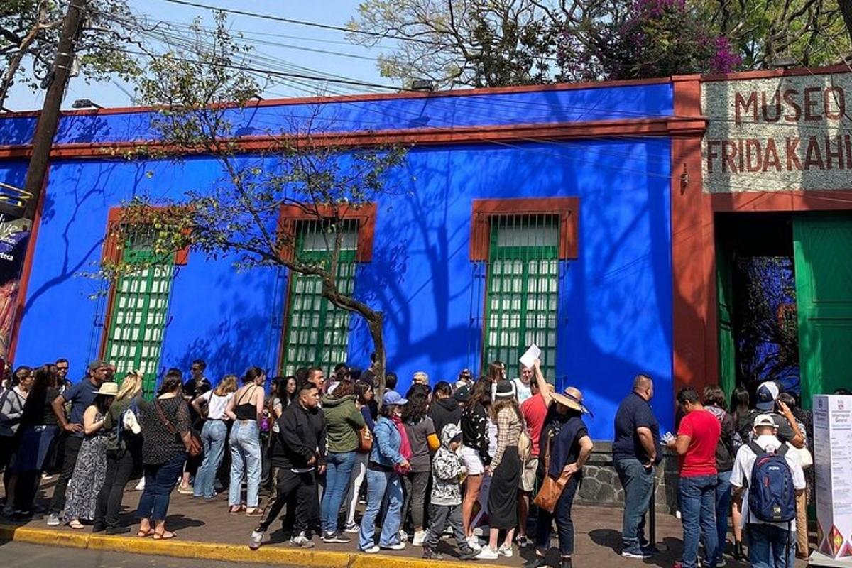a crowd of people standing in front of a blue building