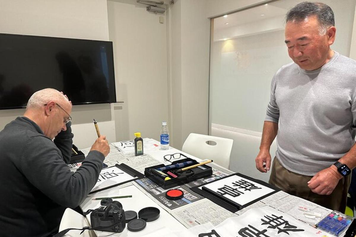 two men standing next to a table with a camera