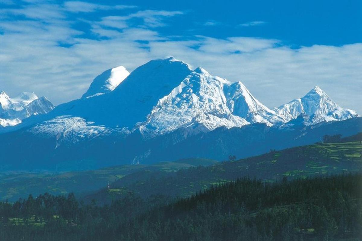 uma montanha com montanhas cobertas de neve ao longe