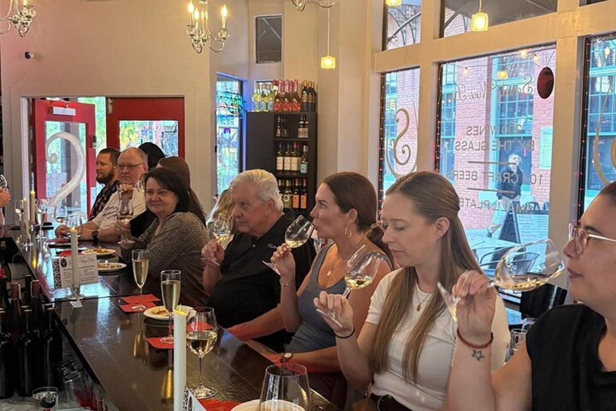 um grupo de pessoas sentadas em um bar bebendo vinho