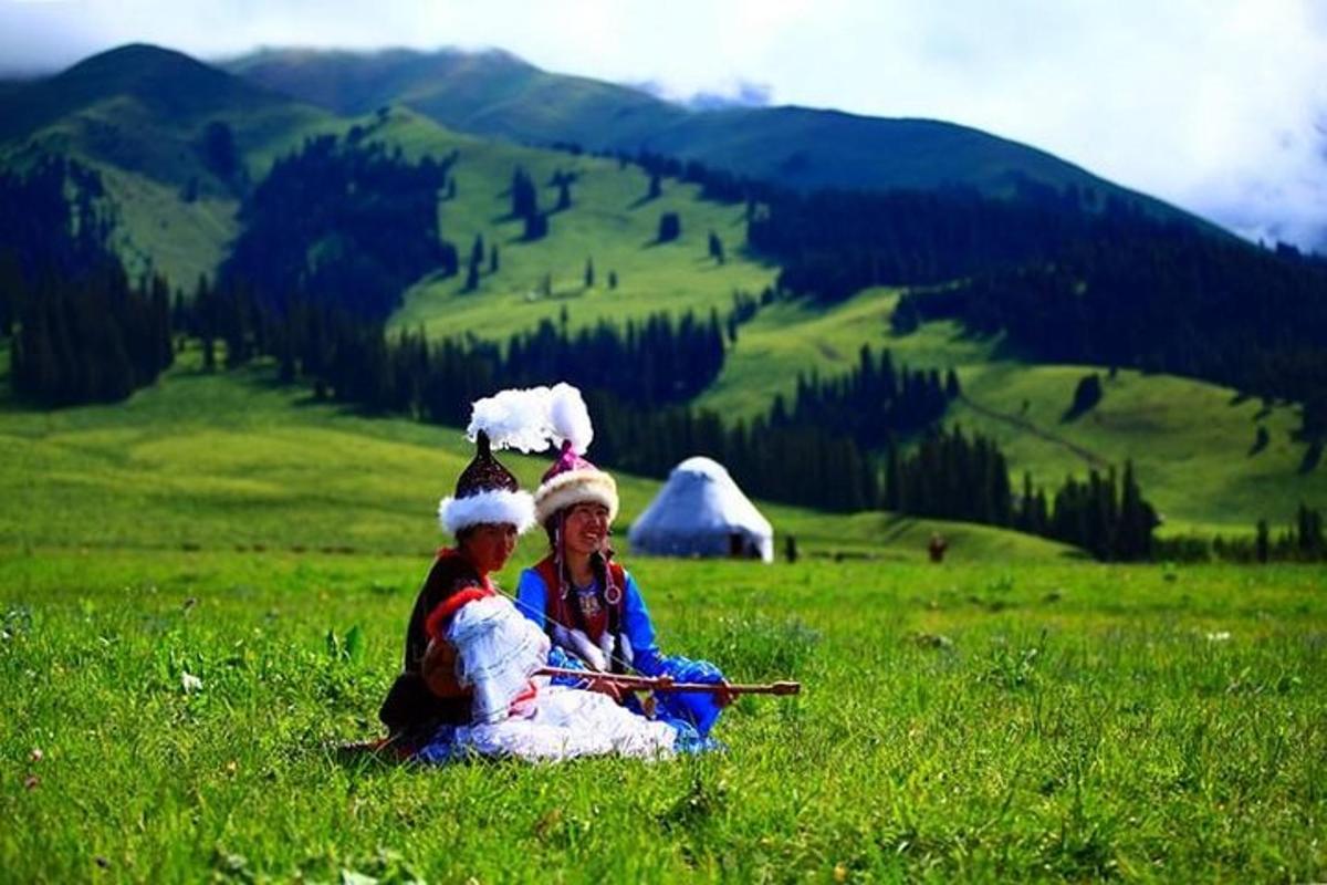 two women sitting in a field of green grass