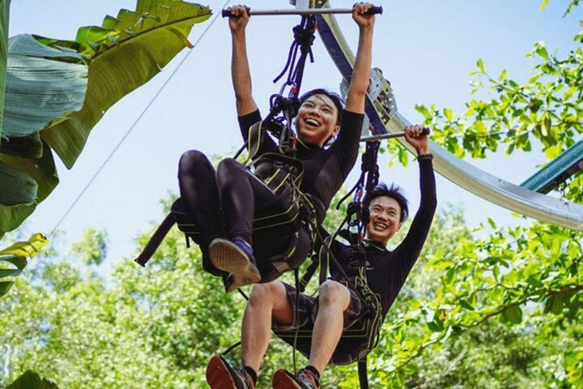 two people on a zip line in the jungle