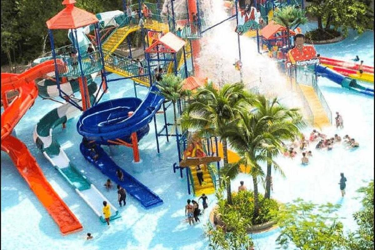 a water park with a slide and people in it
