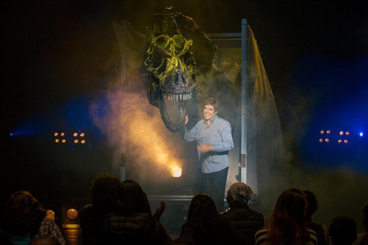 a man standing on a stage in front of a crowd