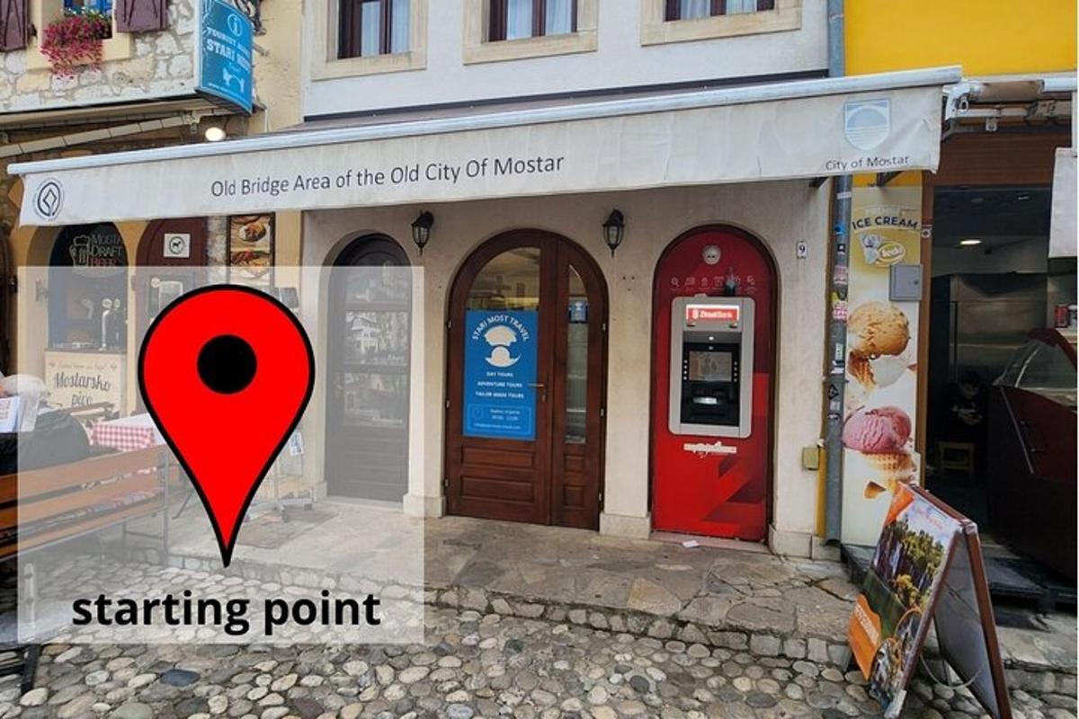 a red sign in front of a store with a starting point