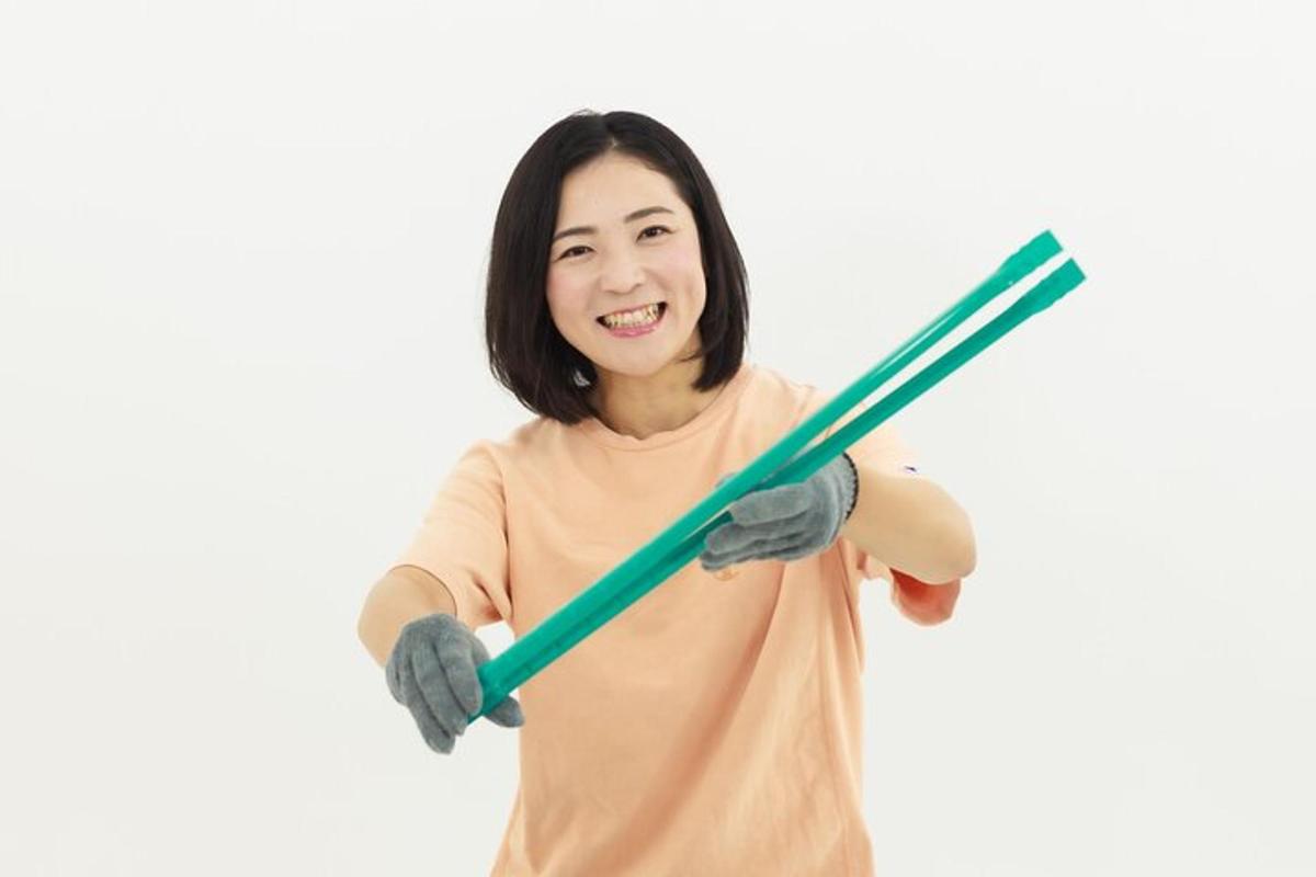 a woman holding two bamboo sticks in her hands