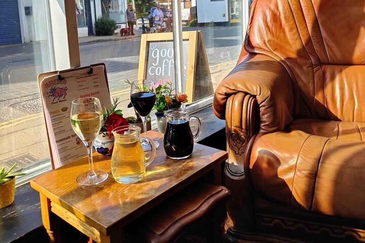 a table with glasses of wine and a leather chair