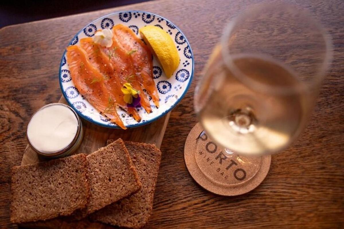 a table with a plate of food and a glass of wine