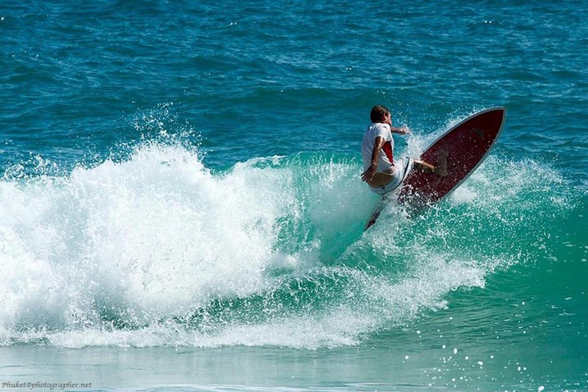 a man riding a wave on a surfboard in the ocean
