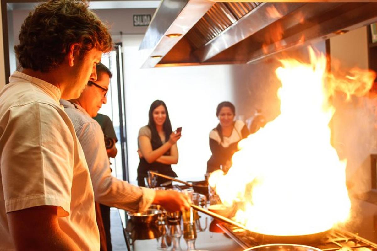 a group of people standing around a fire grill