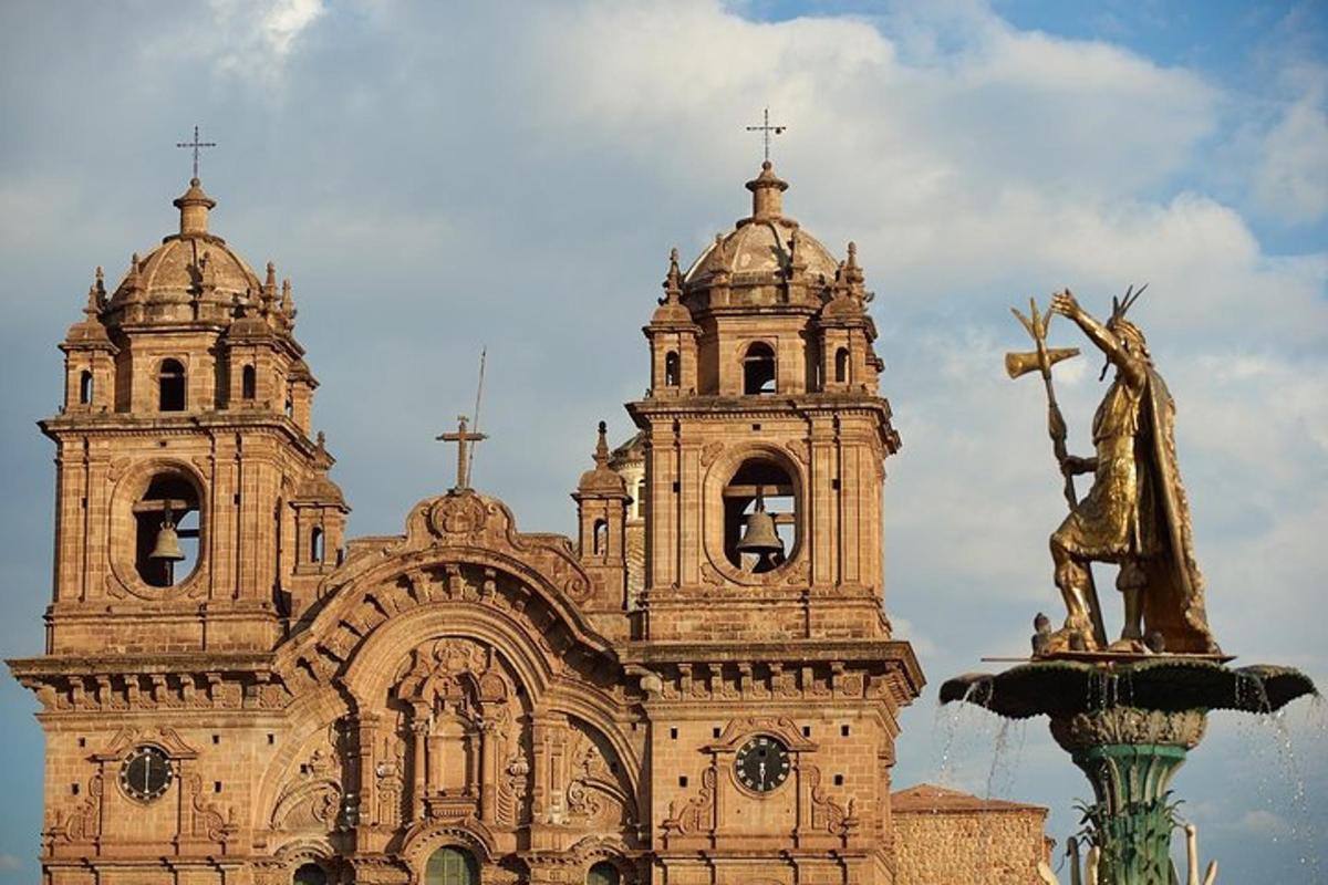 an old church with a statue in front of it