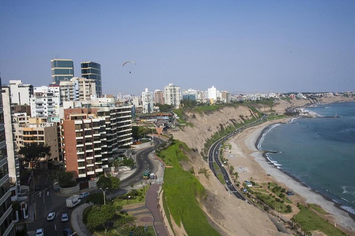 an aerial view of a beach with buildings and the ocean