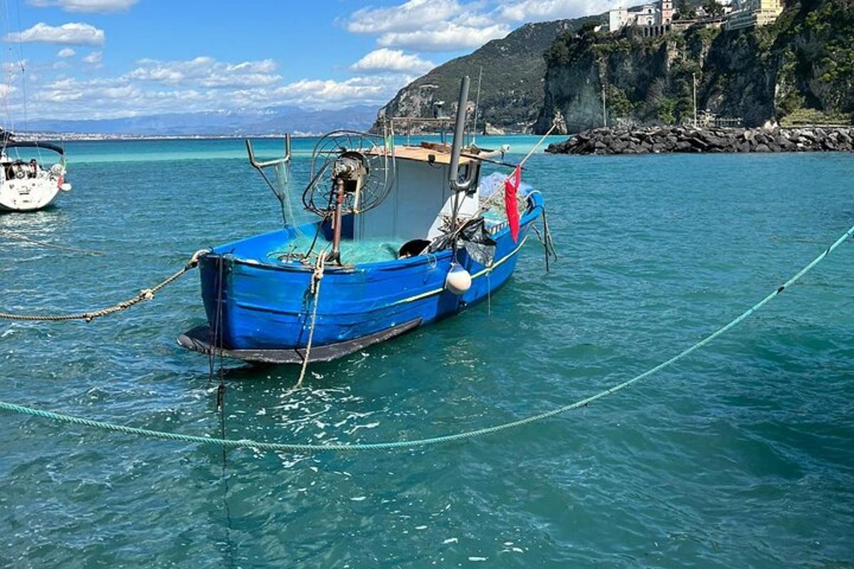 a blue boat in the water in the ocean
