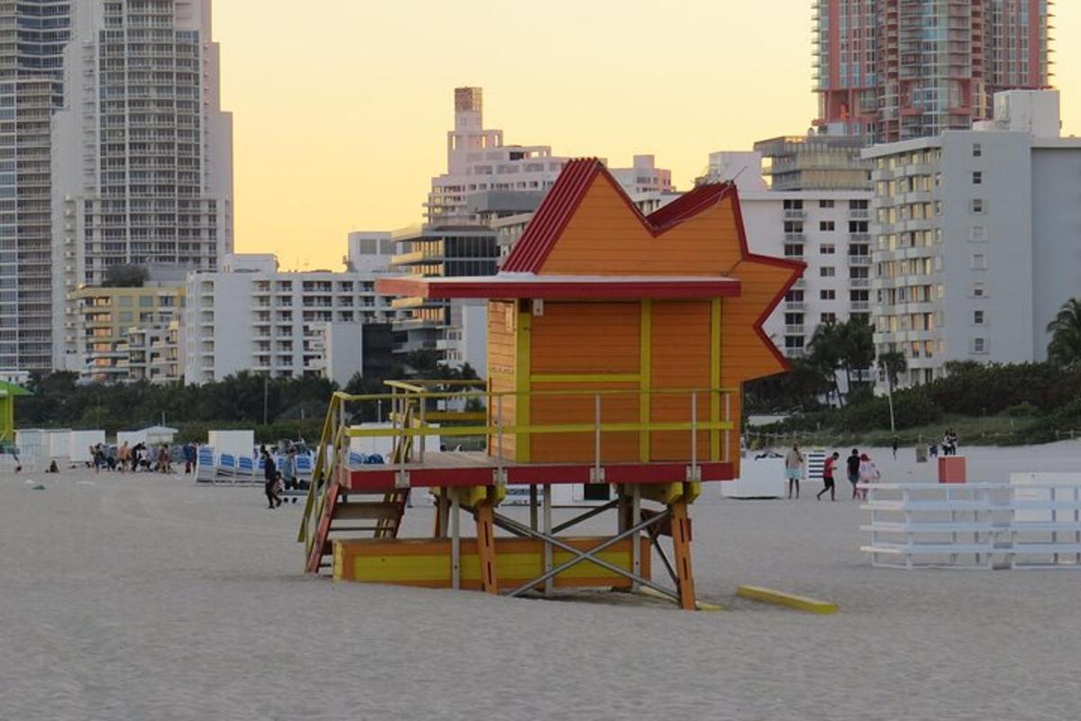 a lifeguard tower on a beach with buildings in the background