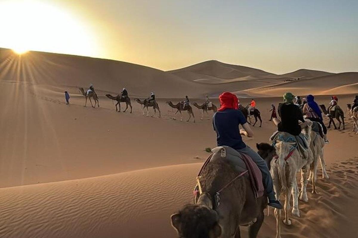 a group of people riding horses in the desert