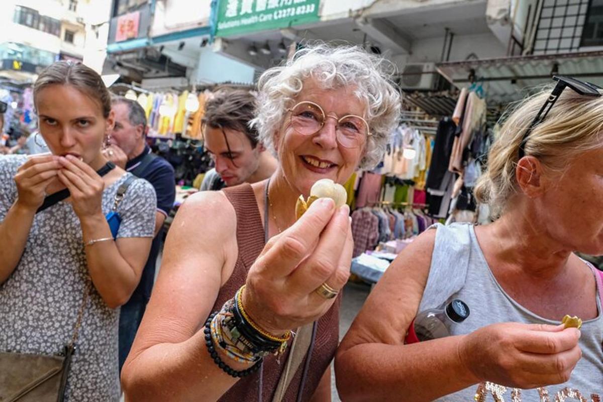 two older women eating food in a market