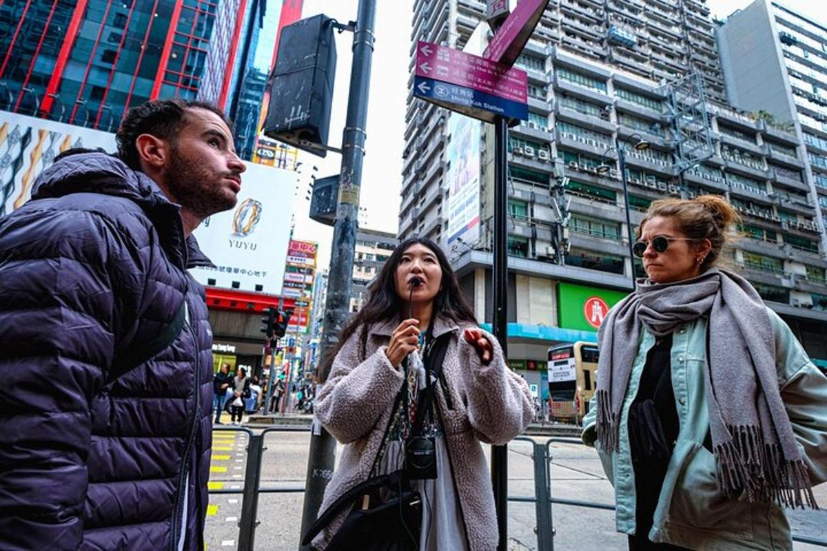a man and two women walking down a city street
