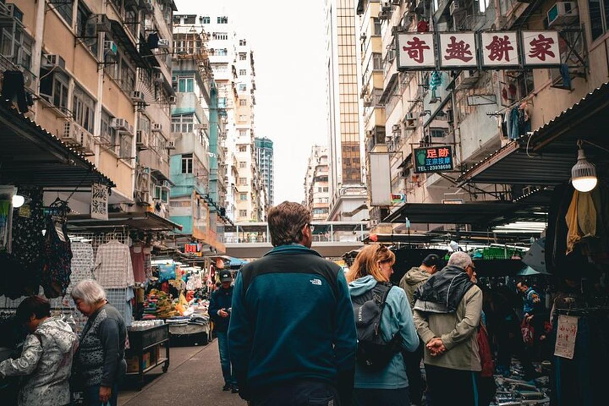 a group of people walking through a market in a city