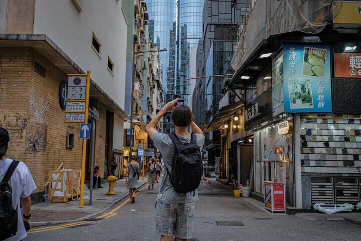 a man with a backpack standing on a city street