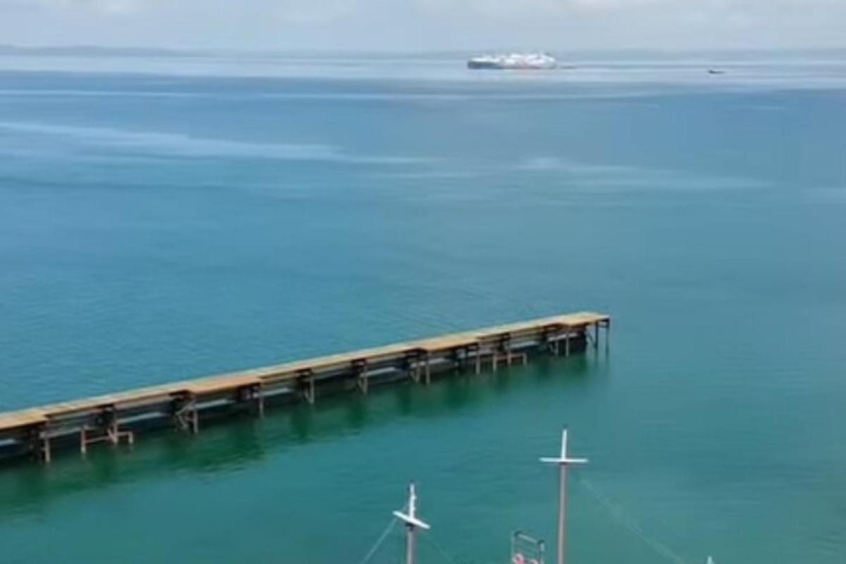 a pier in the water with a boat in the water