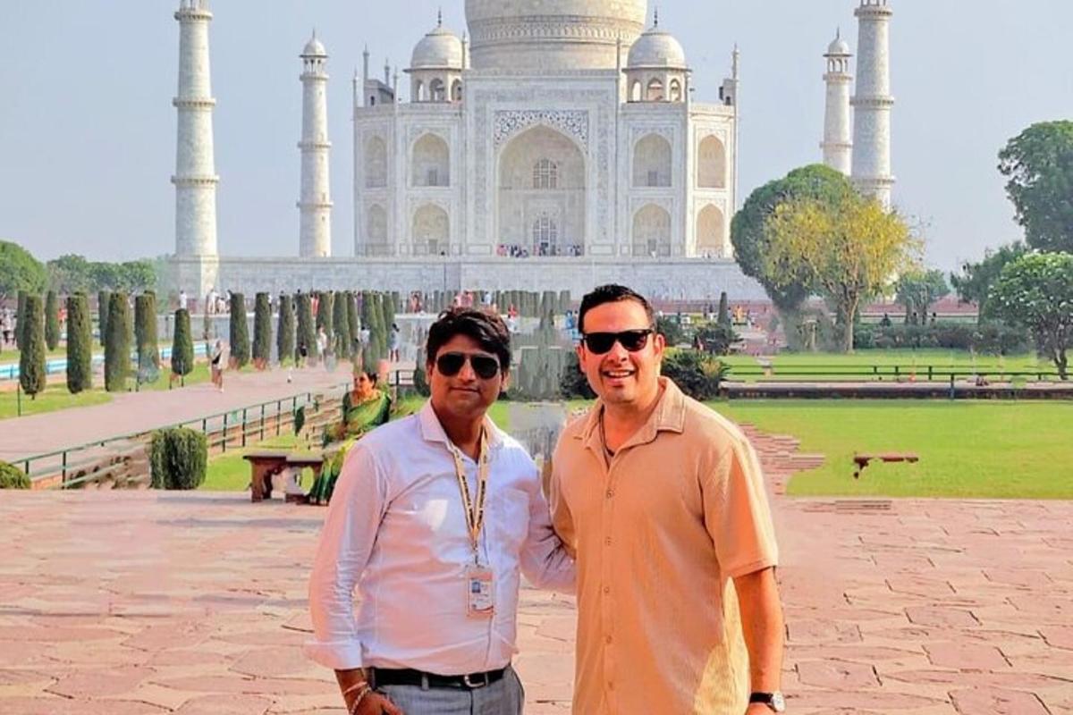 two men standing in front of the taj mahal