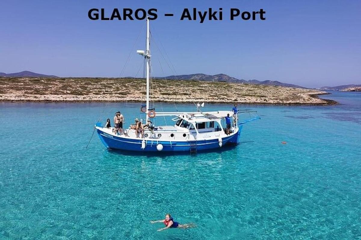 a person swimming in the water in front of a boat