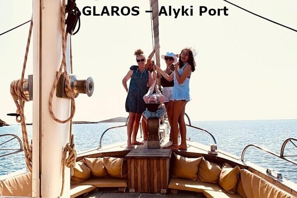 a group of people standing on the back of a boat
